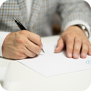 Close-up of a professional signing EDGAR filings on a white document with a pen, wearing a checkered blazer.
