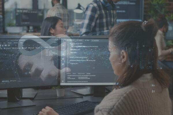 Developers working on software code with flat-rate pricing for managed IT support and professional tech solutions.