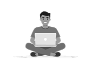 Smiling man sitting cross-legged with a laptop, representing flexible remote working and digital nomad lifestyle.