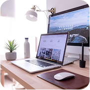Modern desk setup displaying professional investor relations websites and hosting on a laptop and monitor.