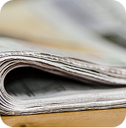 Folded newspaper on a table highlighting professional press release and newswire distribution for media outreach.