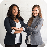 Two professional women offering expert Shareholder Meeting and Annual Meeting Services in a modern office.