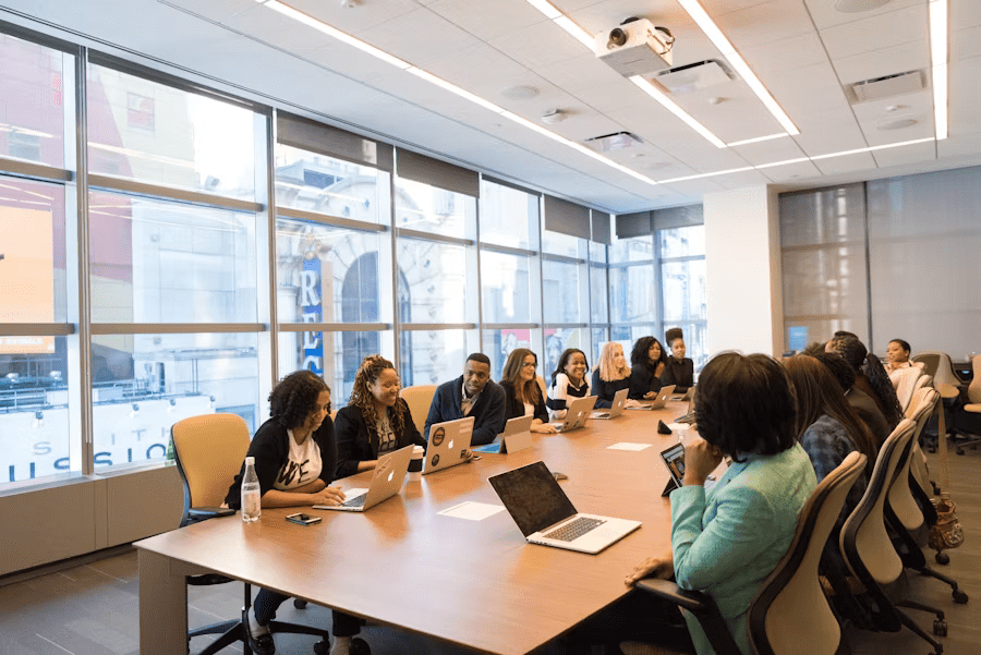 A diverse team meeting in a modern conference room, discussing business strategies and implications of the Securities Exchange Act.