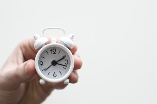 Hand holding a small white alarm clock, highlighting fast same-day revisions and efficient turnaround times. Hand holding a small white alarm clock, highlighting fast same-day revisions and efficient turnaround times.