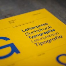 Yellow typography card featuring blue text and terms for Single-Source Typesetting, letterpress, and buchdruck.
