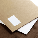 Kraft envelope with a white label for beneficial distribution on a wooden surface.