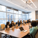 Diverse professionals at a conference table during a free consultation in a bright, modern office.