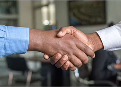 Professionals shake hands, finalizing a business deal related to 10-Q / 10-K Filing compliance or strategy.